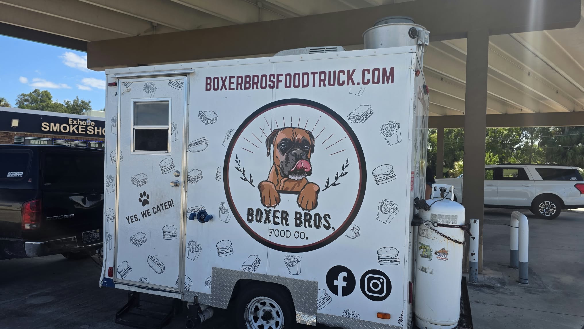 The white Boxer Bros food trailer with its signature boxer dog logo